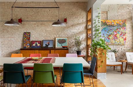 Rustic brick wall, eclectic art, vibrant colors, mid-century modern furnishings.