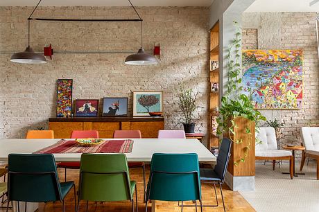 Rustic brick wall, eclectic art, vibrant colors, mid-century modern furnishings.