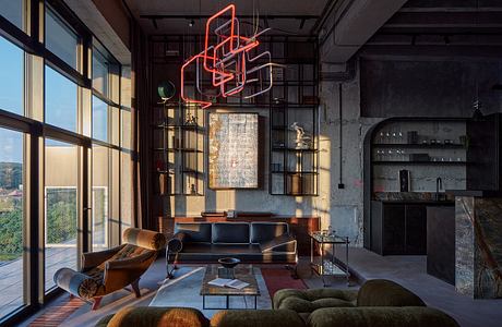 A sleek, industrial-style living space with bold neon lighting and an eclectic mix of furnishings.