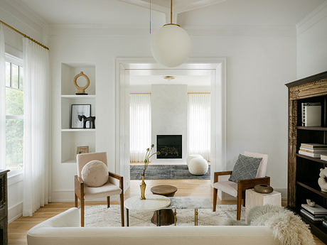 Elegant neutral-toned living room with striking architectural details and furnishings.