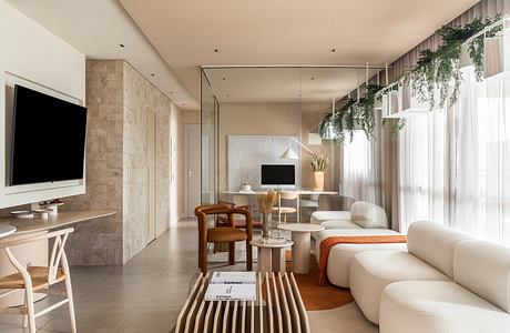 Elegant modern living room with stone walls, natural lighting, and minimalist decor.