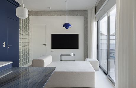 Minimalist living room with sleek, modern furniture and fixtures. Neutral color palette.