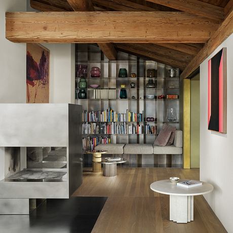 Rustic wooden beams contrast with modern built-in shelving and minimalist decor.