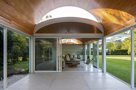 Elegant arched doorway framing a modern, open-concept living space with sliding glass doors.