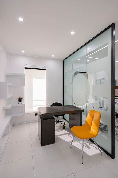 Sleek modern office with minimalist black desk, yellow chair, and full-length glass wall.