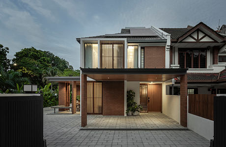 Contemporary brick and timber residence with covered porch and decorative screens.