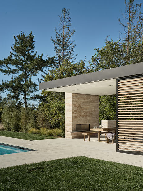 Sleek modern architecture with concrete and wood structures, surrounded by lush greenery.