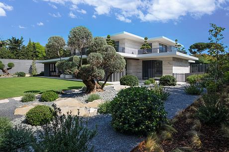 Sleek, modern architecture with lush landscaping and ornamental trees in a manicured garden.