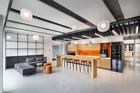 Sleek, modern office space with minimalist furniture, warm wood accents, and geometric lighting.