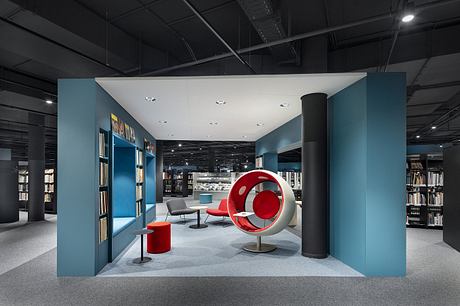 Striking modern interior with bold red furnishings, geometric shapes, and neutral tones.