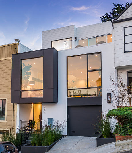 Modern, sleek exterior with black accents, large windows, and landscaped entryway.