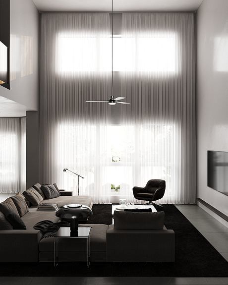 Modern living room with sleek furniture, floor-to-ceiling curtains, and a minimalist ceiling fan.