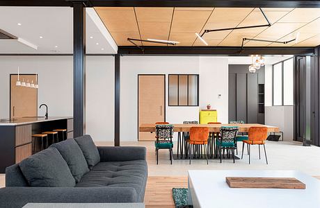 Spacious loft-style interior with exposed beams, wood accents, and modern furnishings.