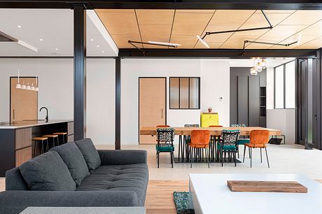 Spacious loft-style interior with exposed beams, wood accents, and modern furnishings.