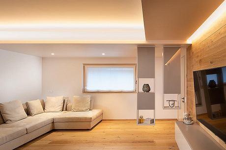 Cozy living room with wooden floor, built-in shelving, and neutral color palette.