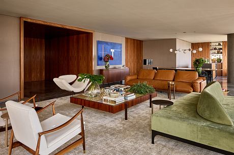 Elegant mid-century modern living room with rich wood paneling, plush furnishings, and eye-catching artwork.