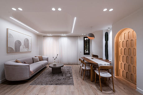 Minimalist living room with modern decor, wooden dining area, and sculptural lighting.