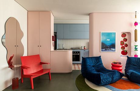 Cozy, colorful interior with retro furniture, modern kitchen, and playful decor elements.