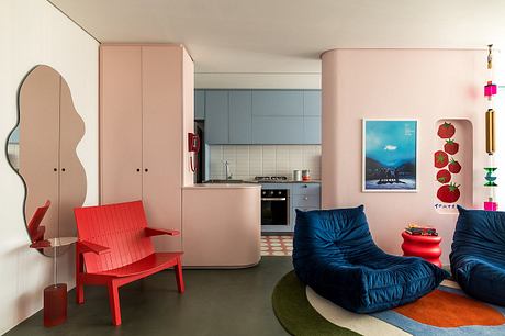 Cozy, colorful interior with retro furniture, modern kitchen, and playful decor elements.