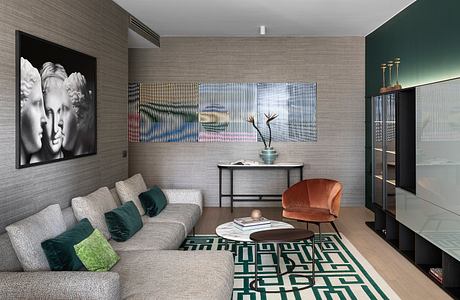 Contemporary living room with textured walls, geometric rug, and mix of modern furniture.