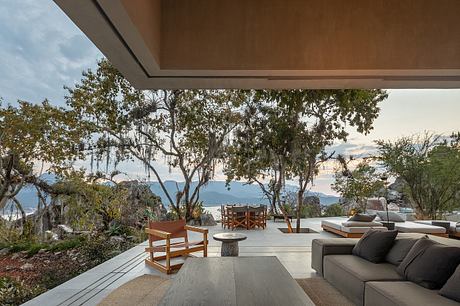 Expansive covered terrace with modern, nature-inspired furnishings and panoramic views.