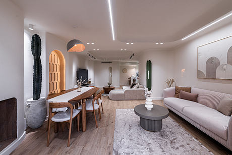 Minimalist, contemporary living space with earthy wooden furniture, statement lighting, and abstract art.