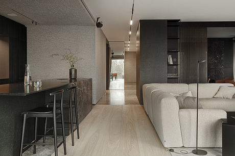 Minimalist living space featuring sleek, modern furnishings and a long, open hallway.