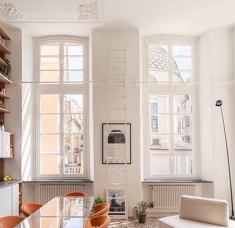 Elegant interior featuring arched windows, built-in shelves, and warm lighting.