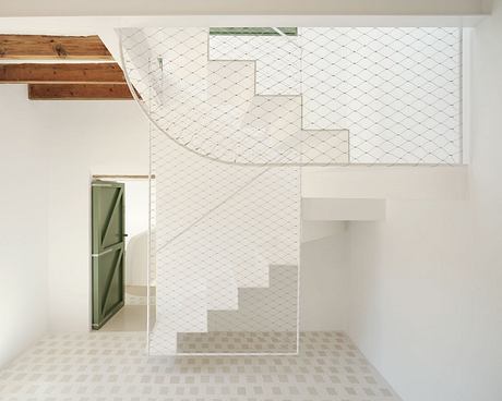 Minimalist architecture with geometric patterns, wooden details, and a white staircase.
