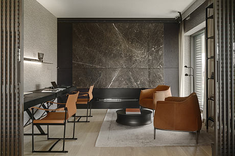Minimalist home office with dark marble walls, leather armchairs, and a sleek black desk.