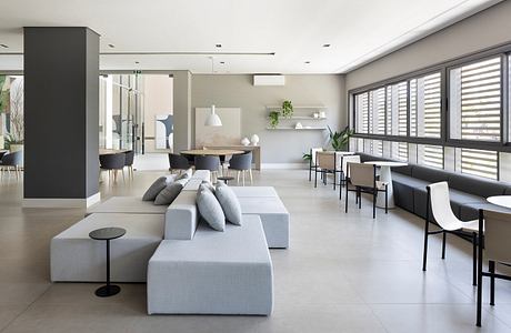 Bright, modern living space with minimalist furniture, clean lines, and large windows.