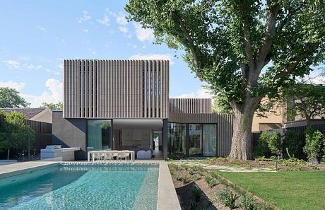 Modern architectural home with sleek wooden panels, expansive windows, and a sparkling pool.