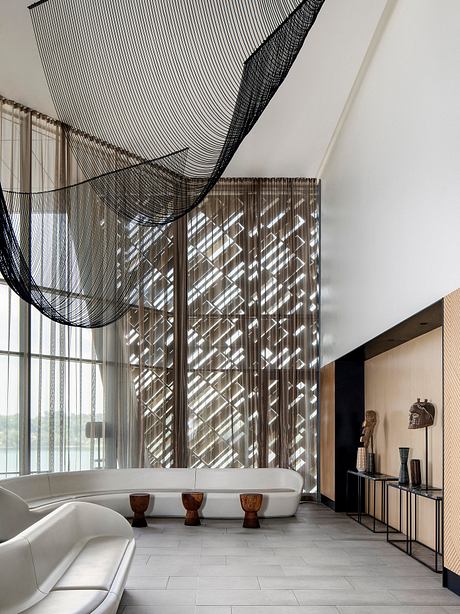 Striking geometric curtain and glass walls create a modern, sculptural space.
