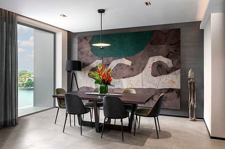 Sleek modern dining area with bold textured wall, pendant lighting, and nature-inspired decor.