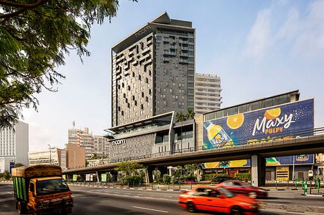 Striking modern architecture of the Novotel hotel with dramatic geometric facade design.