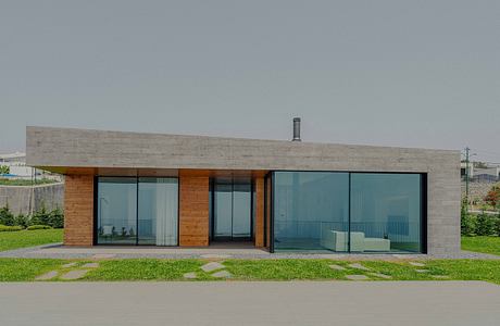 A modern single-story residence with a concrete facade, large glass windows, and a wooden roof.