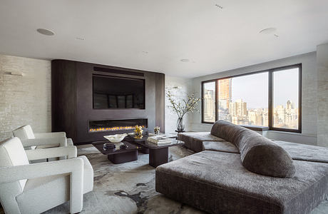 Modern living room with panoramic city view, dark furniture, fireplace, and minimalist decor.