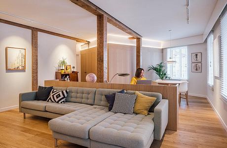 Spacious living room with wooden beams, plush sectional sofa, and modern furniture.