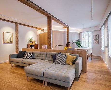 Spacious living room with wooden beams, plush sectional sofa, and modern furniture.