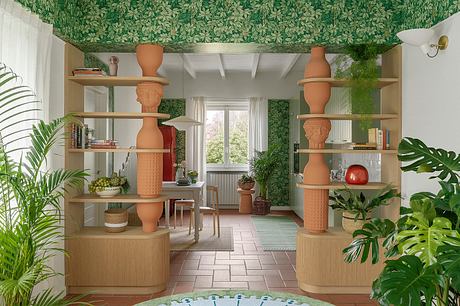 A warm, lush interior featuring wooden shelves, terracotta accents, and vibrant greenery.