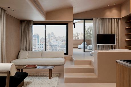 Spacious modern living room with large windows, neutral tones, and minimalist design.