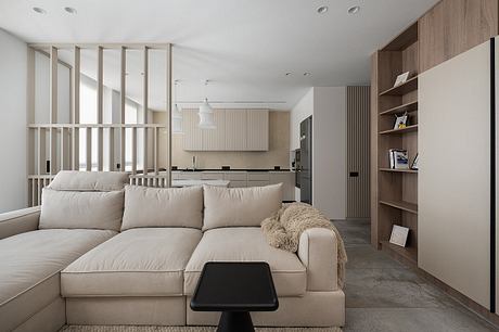 Minimalist living room design with neutral tones, wood accents, and a sleek, modular sofa.