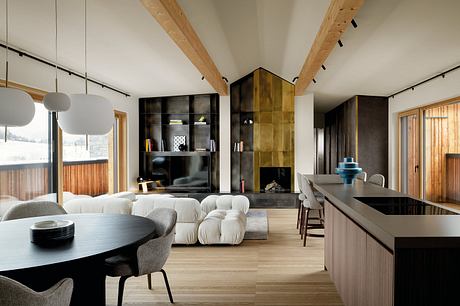 Spacious open-concept interior with wooden beams, dark cabinetry, and a mix of modern and rustic elements.