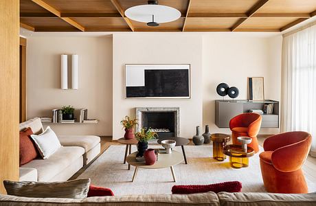 Cozy living room with wooden ceiling beams, modern furnishings, and vibrant accents.