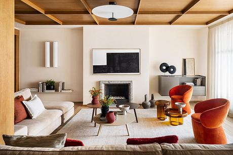 Cozy living room with wooden ceiling beams, modern furnishings, and vibrant accents.