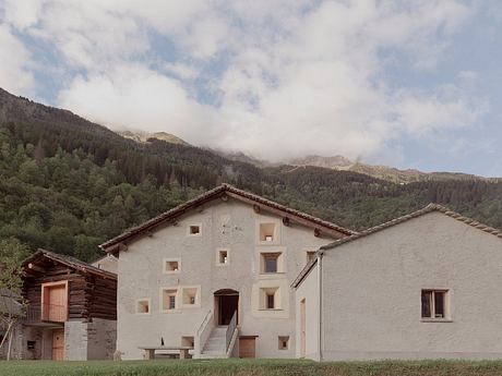 A quaint stone building with a rustic charm, nestled amidst the lush mountain landscape.