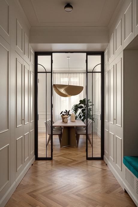 Elegant hallway with arched glass doors, wooden floors, and modern pendant lighting.