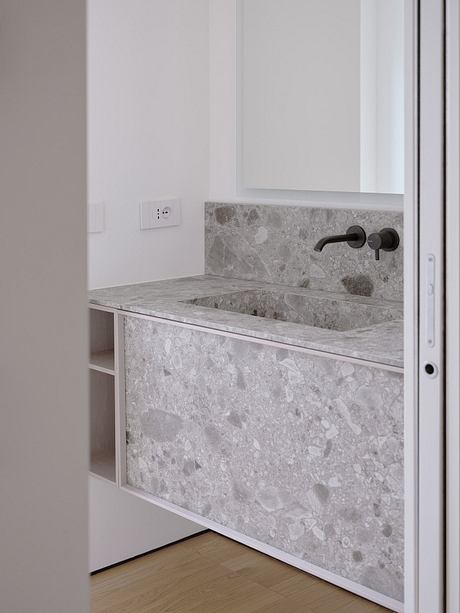 Modern vanity with a sleek, minimal design and a gray marble countertop.