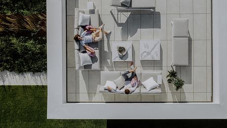 Minimalist glass-enclosed room showcases creative modular furniture arrangement.