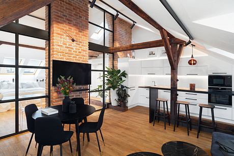 Exposed brick walls, wooden beams, and modern kitchen design in an open-concept loft.